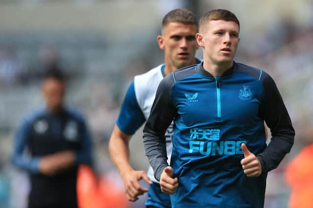 Newcastle United's English midfielder Elliot Anderson warms up prior to the English Premier League football match between Newcastle United and Manchester City at St James' Park in Newcastle-upon-Tyne, north east England, on August 21, 2022.  (Photo by LINDSEY PARNABY/AFP via Getty Images)