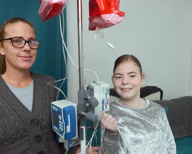Mother Katy Jones and daughter Hannah Jones with the total parental nutrition machine used to feed Hannah.