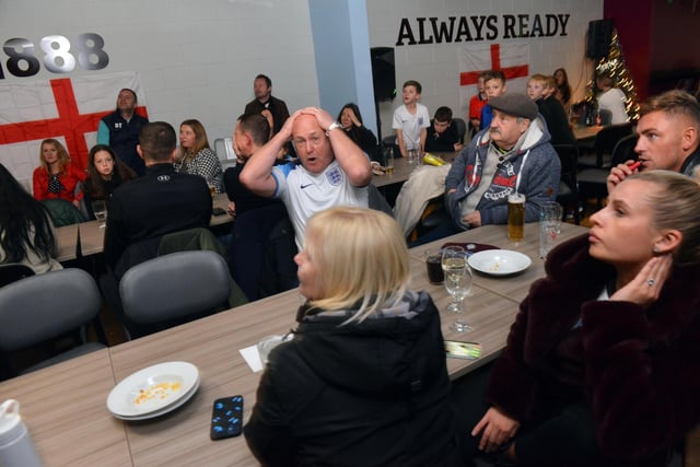 An England fan has his head in his hands as England go close to scoring.