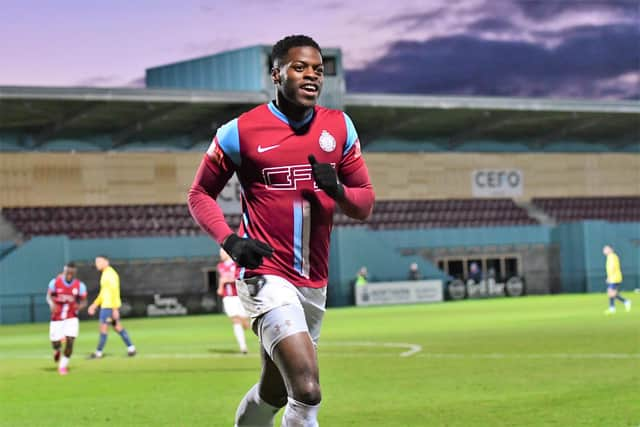 JJ Hooper, celebrating a goal against Gainsborough Trinity, with the new CEFO Ground Stand behind him. Picture: KEV WILSON.