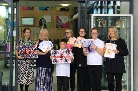 Staff and students at Epinay School with their tributes to the Queen