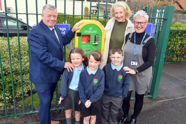 From left: Paul O'Doherty from the Freemasons, with teaching assistant Nicola O'Doherty and executive headteacher Helen Smith, plus pupils from St Oswald's Primary School.