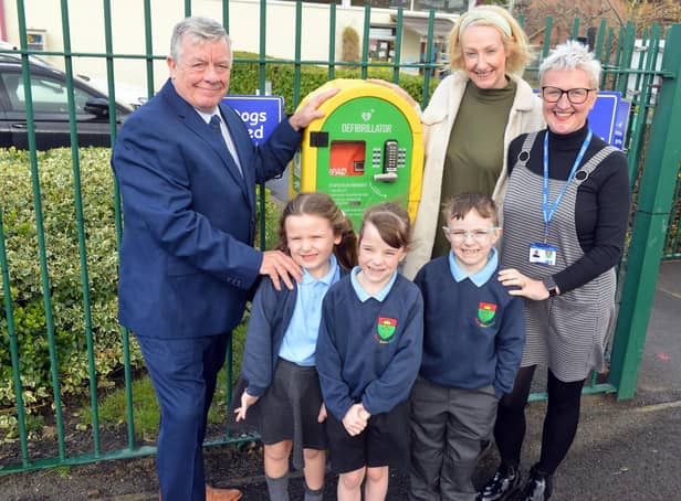 From left: Paul O'Doherty from the Freemasons, with teaching assistant Nicola O'Doherty and executive headteacher Helen Smith, plus pupils from St Oswald's Primary School.