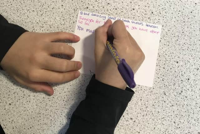 Pupils writing their postcards.