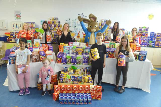 Viv Watts of Hope 4 Kids with young patients and some of the Easter eggs at Sunderland Royal Hospital.