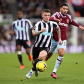 Kieran Trippier of Newcastle United runs ahead of Said Benrahma of West Ham United during the Premier League match between Newcastle United and West Ham United at St. James Park on February 04, 2023 in Newcastle upon Tyne, England. (Photo by George Wood/Getty Images)