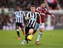 Kieran Trippier of Newcastle United runs ahead of Said Benrahma of West Ham United during the Premier League match between Newcastle United and West Ham United at St. James Park on February 04, 2023 in Newcastle upon Tyne, England. (Photo by George Wood/Getty Images)