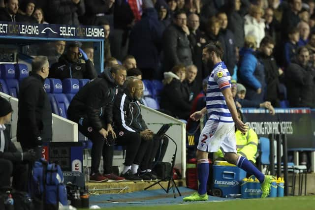 Reading striker Andy Carroll leaves the pitch after being sent off.