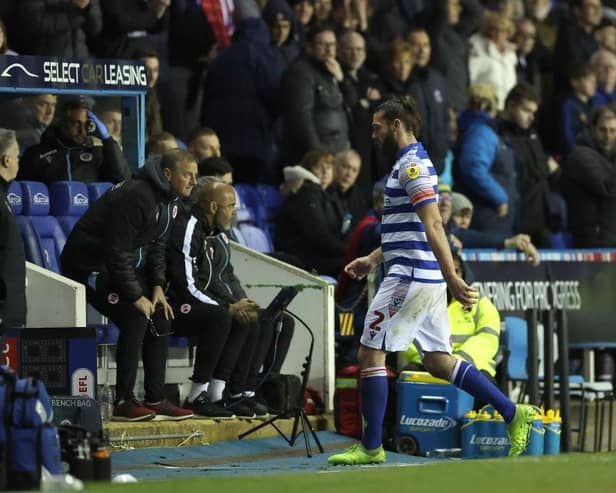 Reading striker Andy Carroll leaves the pitch after being sent off.