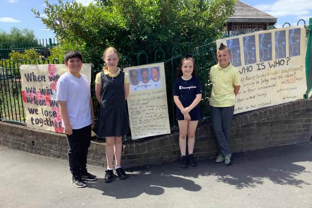 Jarrow Cross C of E Primary School pupils Jay Dykta Robinson, Lennon Appleby, Ella Tuthill and Sophia Langley with the posters outside of the school.