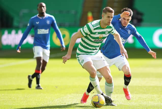 Ajer of Celtic vies with Ianis Hagi of Rangers during the Ladbrokes Scottish Premiership match between Celtic and Rangers at Celtic Park.