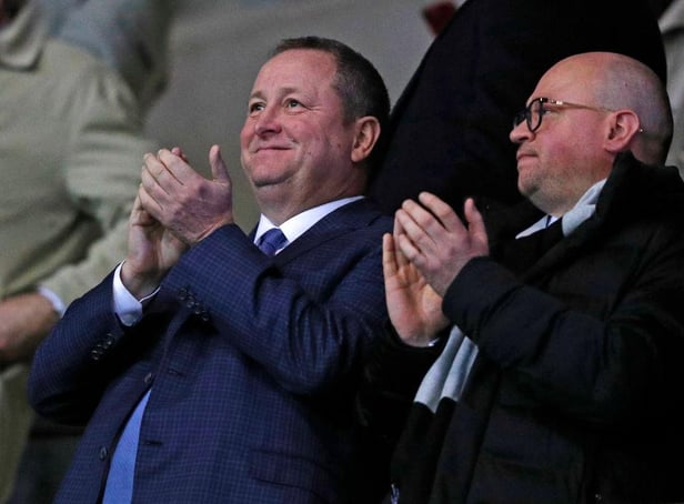 Newcastle United's English owner Mike Ashley (L) and director Lee Charnley (R) applaud after Newcastle take the lead during the FA Cup fourth round replay football match between Oxford United and Newcastle United at the Kassam Stadium in Oxford, west of London, on February 4, 2020.