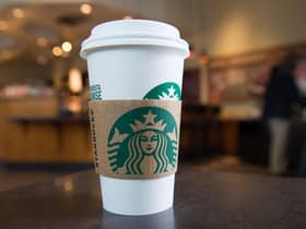 A Starbucks coffee cup (Photo by SAUL LOEB/AFP via Getty Images)