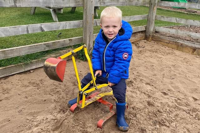 Elijah playing on the digger at the farm