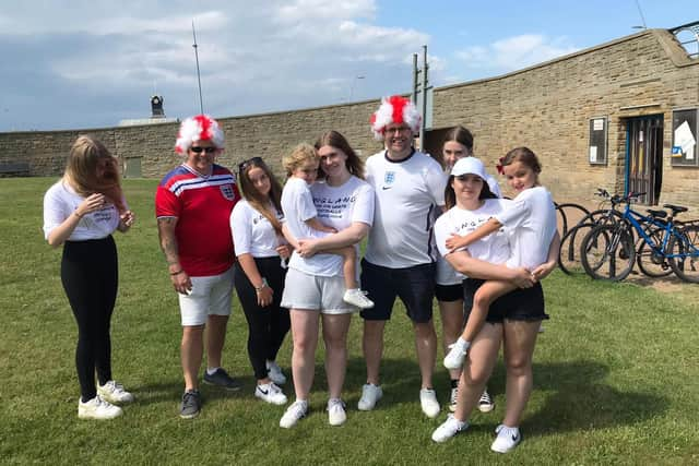 Dean and Dan Hutchinson, in their England wigs, pictured with their family in South Shields.