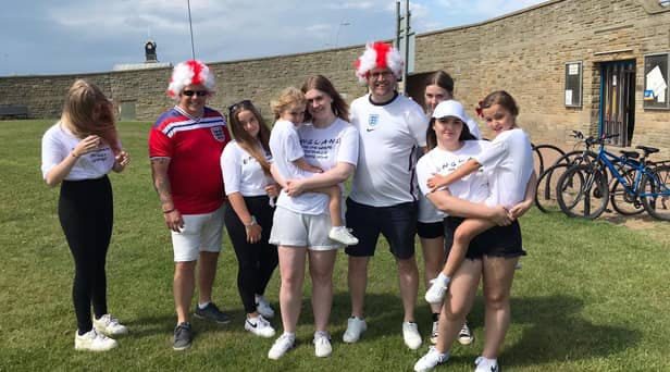 Dean and Dan Hutchinson, in their England wigs, pictured with their family in South Shields.