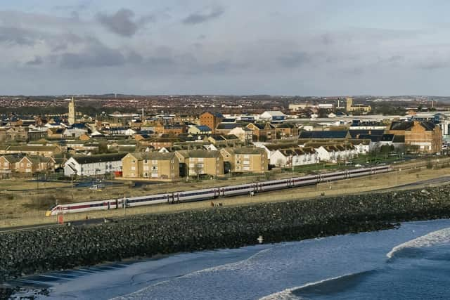 A LNER Azuma train passing Hartlepool seafront.