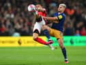 Renan Lodi of Nottingham Forest is challenged by Bruno Guimaraes. (Photo by Shaun Botterill/Getty Images).