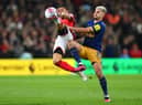 Renan Lodi of Nottingham Forest is challenged by Bruno Guimaraes. (Photo by Shaun Botterill/Getty Images).