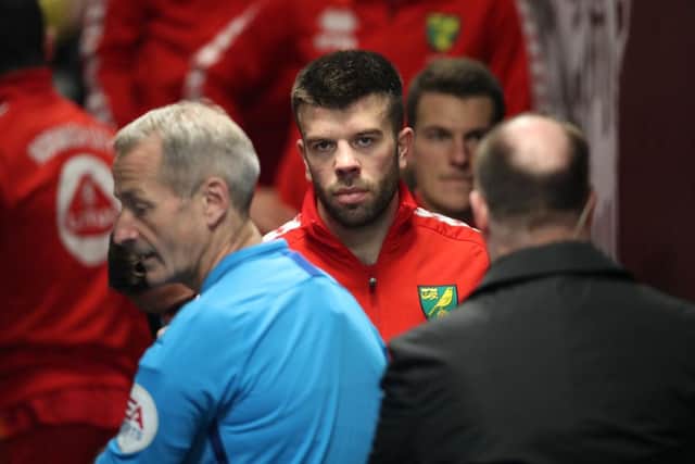 Grant Hanley prepares to lead Norwich City out at St James's Pask last year.
