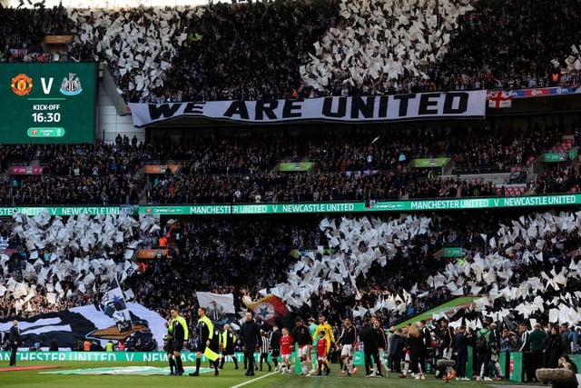 The teams take to the field as Newcastle United fans wave flags and show their support prior to the Carabao Cup Final match between Manchester United and Newcastle United. (Photo by Julian Finney/Getty Images).
