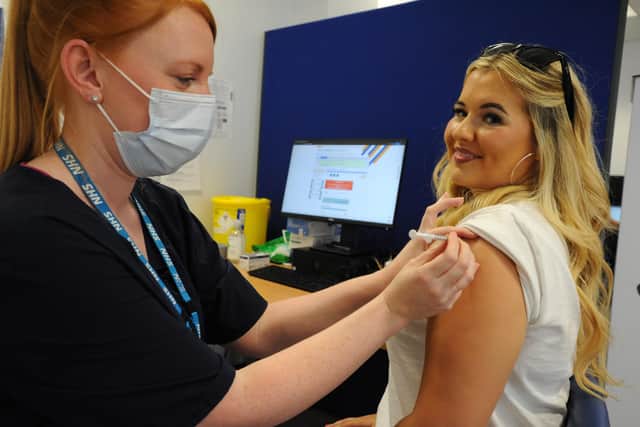 Lauren Amour, pictured with vaccinator Emma Dixon, overcame her fear of needles to get her coronavirus vaccine and is urging other young people to do the same.
