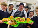 Stanhope Primary School cook Lynn Curtin ahead of International School Meals Day. The pupils pictured are, from left Cody Headley, Bisma Khawaja, Jaspreet Singh, Jessica Paul, and Emily Kouhy.