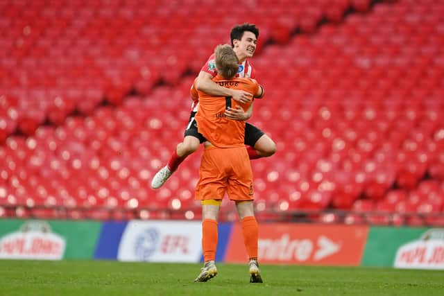 Lee Burge of Sunderland celebrates victory with teammate Luke O'Nien following the Papa John's Trophy Final match between Sunderland and Tranmere Rovers.