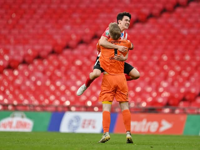 Lee Burge of Sunderland celebrates victory with teammate Luke O'Nien following the Papa John's Trophy Final match between Sunderland and Tranmere Rovers.