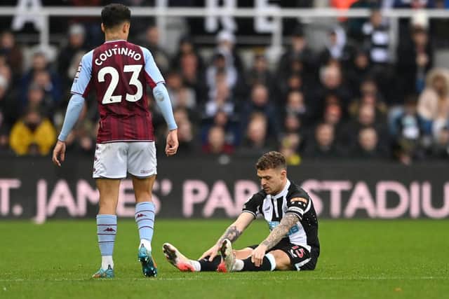 NEWCASTLE UPON TYNE, ENGLAND - FEBRUARY 13: Newcastle full back Kieran Trippier sits down on the turf before leaving the field with an injury during the Premier League match between Newcastle United and Aston Villa at St. James Park on February 13, 2022 in Newcastle upon Tyne, England. (Photo by Stu Forster/Getty Images)