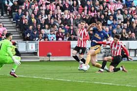 Newcastle United's English defender Dan Burn (2R) fails to score during the English Premier League football match between Brentford and Newcastle United at Gtech Community Stadium in London on April 8, 2023. (Photo by Glyn KIRK / AFP)