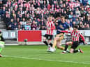 Newcastle United's English defender Dan Burn (2R) fails to score during the English Premier League football match between Brentford and Newcastle United at Gtech Community Stadium in London on April 8, 2023. (Photo by Glyn KIRK / AFP)