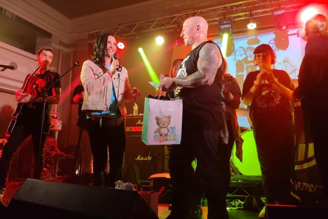 Mensi's daughter Victoria presented stand-in singer Chris Wright with a gift - in a distinctly un-punk bag.