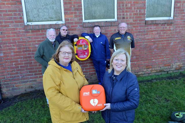 West Park Community Group's Suzanne Oliver and Alison Docherty, with Jarrow Bowling Club members with the new defibrillator.