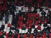 Fans react during the Premier League match between Liverpool and Tottenham Hotspur at Anfield in December. (Photo by Jon Super - Pool/Getty Images)