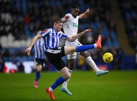 Mark McGuinness of Sheffield Wednesday battles for possession with Alexander Isak of Newcastle United during the Emirates FA Cup Third Round match between Sheffield Wednesday and Newcastle United at Hillsborough on January 07, 2023 in Sheffield, England. (Photo by Laurence Griffiths/Getty Images)