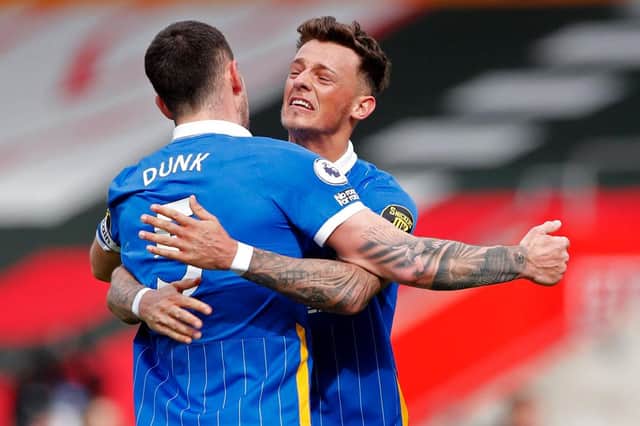 Lewis Dunk and Ben Whilte celebrates Brighton and Hove Albion's win over Southampton.