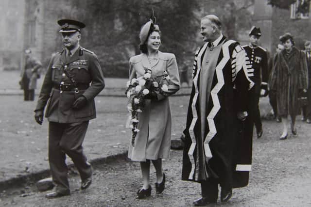 Princess Elizabeth enjoying a joke with Dr J. F. Duff, Warden of the Durham Colleges, as she walks through the grounds of St Mary’s College escorted by Col Robert Chapman, Vice-Lieutenant of County Durham, in October 1947.