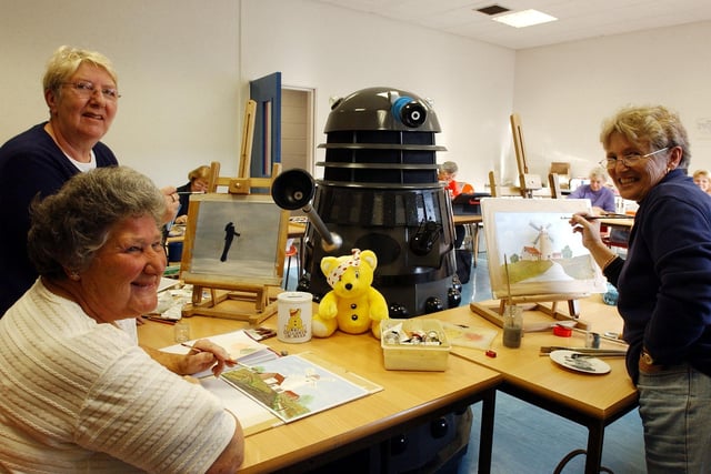 Adult education art students Margaret Bell, Anne Price and Ann Milne were joined by a Dalek for their art lesson in 2003.