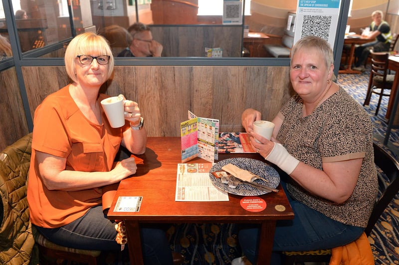 Deborah Ward and Hilary Johnson enjoy breakfast and hot drinks on the first day indoor dining returns at Spa Lane Vaults.