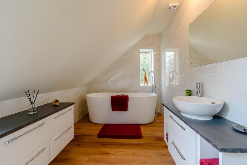 This en suite bathroom with contemporary freestanding bath can be found on the second floor.