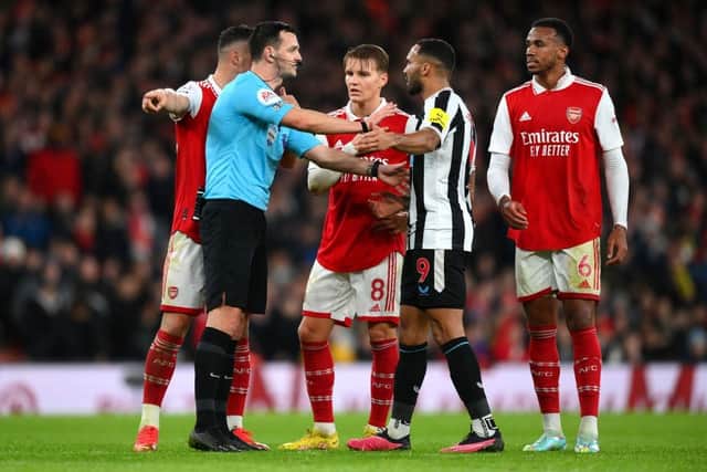 Referee Andy Madley speaks to Newcastle United's Callum Wilson.