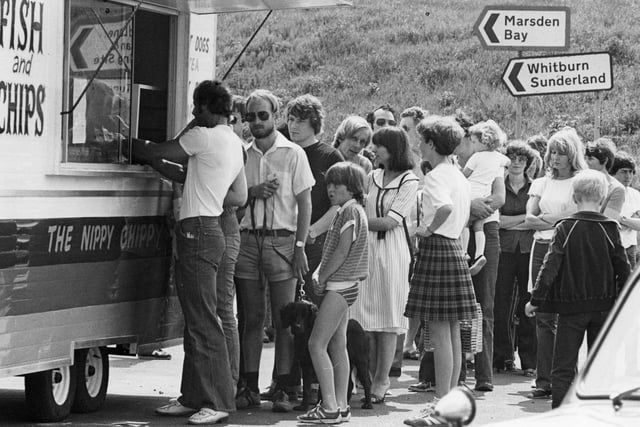 Queuing at the Nippy Chippy for a tasty fish and chips meal on a hot day. Remember this?