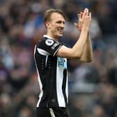 Dan Burn applauds Newcastle United fans after the final whistle.