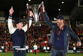 Hollywood stars Rob McElhenney and Ryan Reynolds, the owners of Wrexham celebrate with the Vanarama National League trophy in Apairl. MK Dons will start the new sky Bert League Two season at the Racecourse Ground (Picture: Jan Kruger/Getty Images)