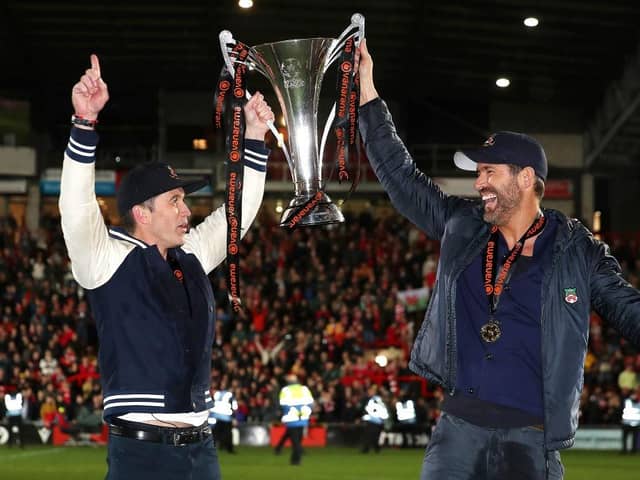 Hollywood stars Rob McElhenney and Ryan Reynolds, the owners of Wrexham celebrate with the Vanarama National League trophy in Apairl. MK Dons will start the new sky Bert League Two season at the Racecourse Ground (Picture: Jan Kruger/Getty Images)
