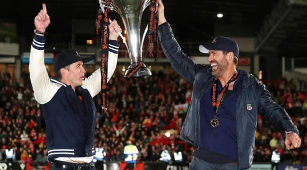 Hollywood stars Rob McElhenney and Ryan Reynolds, the owners of Wrexham celebrate with the Vanarama National League trophy in Apairl. MK Dons will start the new sky Bert League Two season at the Racecourse Ground (Picture: Jan Kruger/Getty Images)