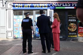 Prime Minister Andy Burnham and Housing Secretary Angela Rayner speak with police officers outside a vape shop as part of his tour of the UK to give local people a real say over the future of their high streets, including a crackdown on vape and betting shops.