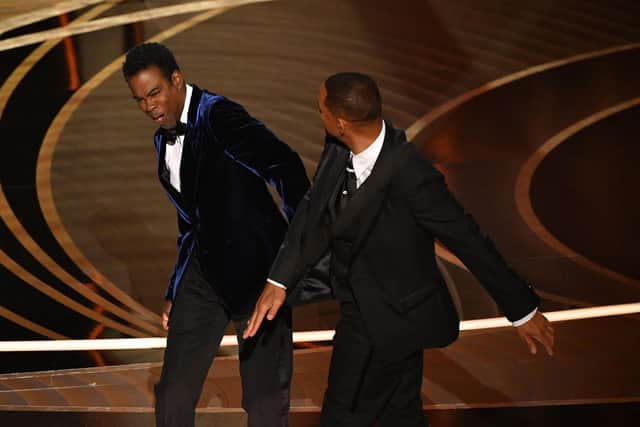 Will Smith (R) slaps US actor Chris Rock onstage during the 94th Oscars at the Dolby Theatre in Hollywood, California. (Photo by ROBYN BECK/AFP via Getty Images)