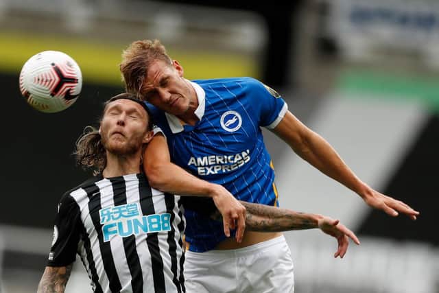 Newcastle United's Irish midfielder Jeff Hendrick (L) jumps for a header with Brighton's English defender Dan Burn during the English Premier League football match between Newcastle United and Brighton and Hove Albion at St James' Park in Newcastle upon Tyne, north-east England on September 20, 2020 (Photo by LEE SMITH/POOL/AFP via Getty Images)